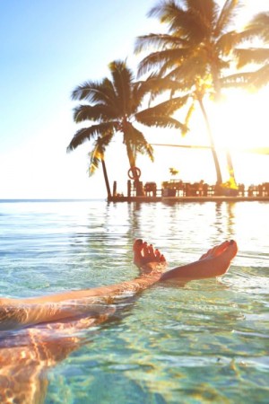Legs of caucasian girl relaxing in tropical ocean